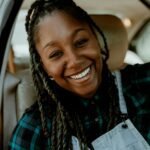 smiling woman in blue and black plaid shirt